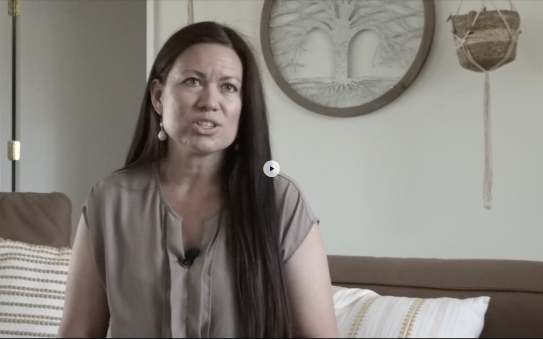A mother at 29:Eleven holding her baby, from the CBS 8 segment